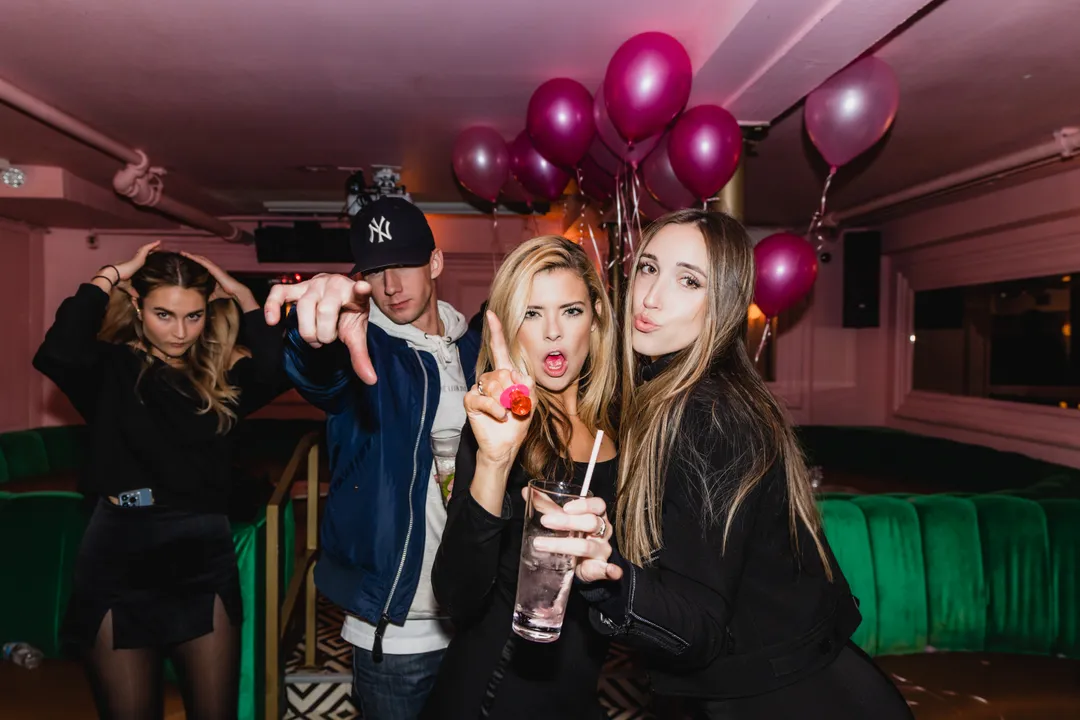 Birthday guests making playful poses for the camera