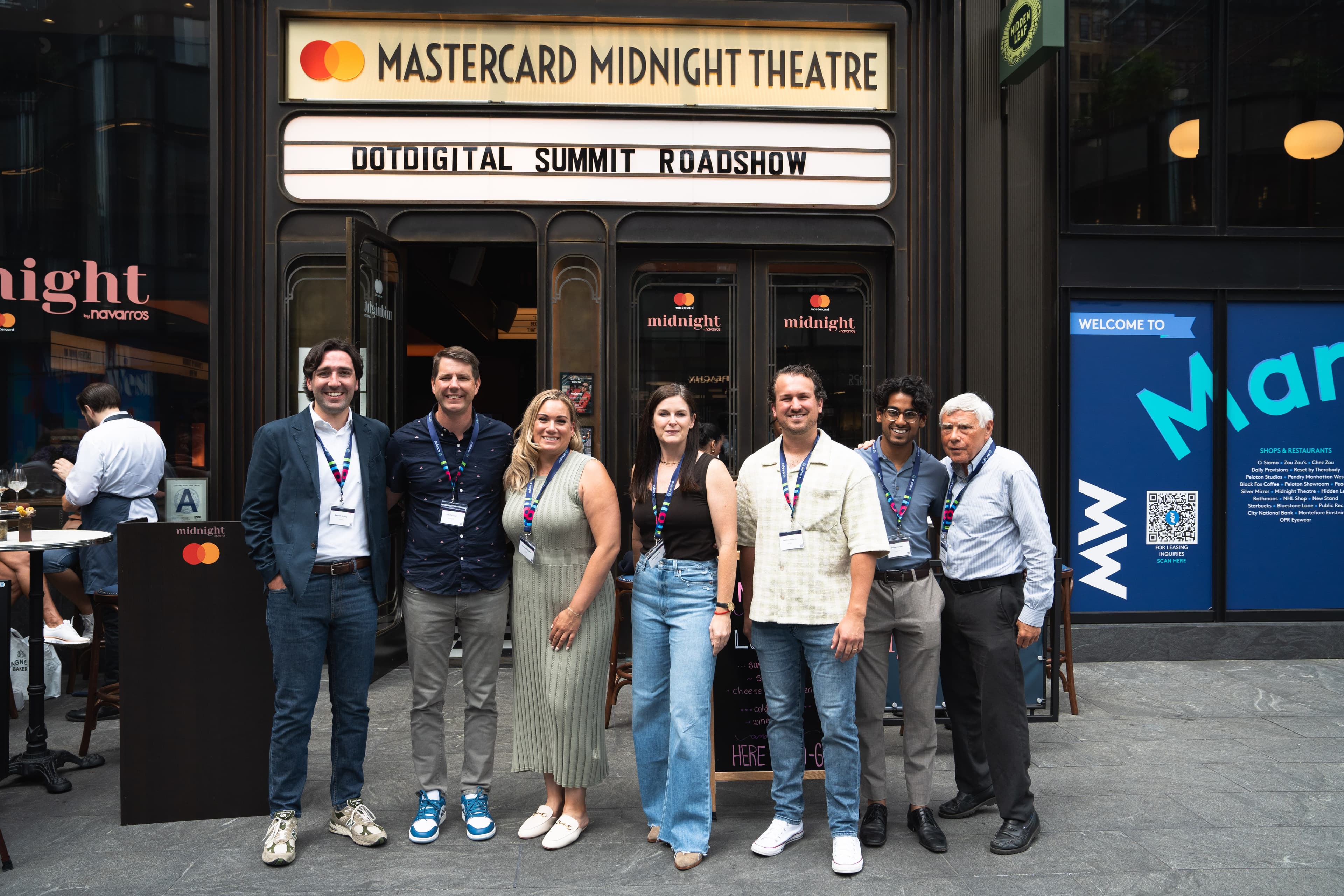 Group photo outside a branded theatre marquee