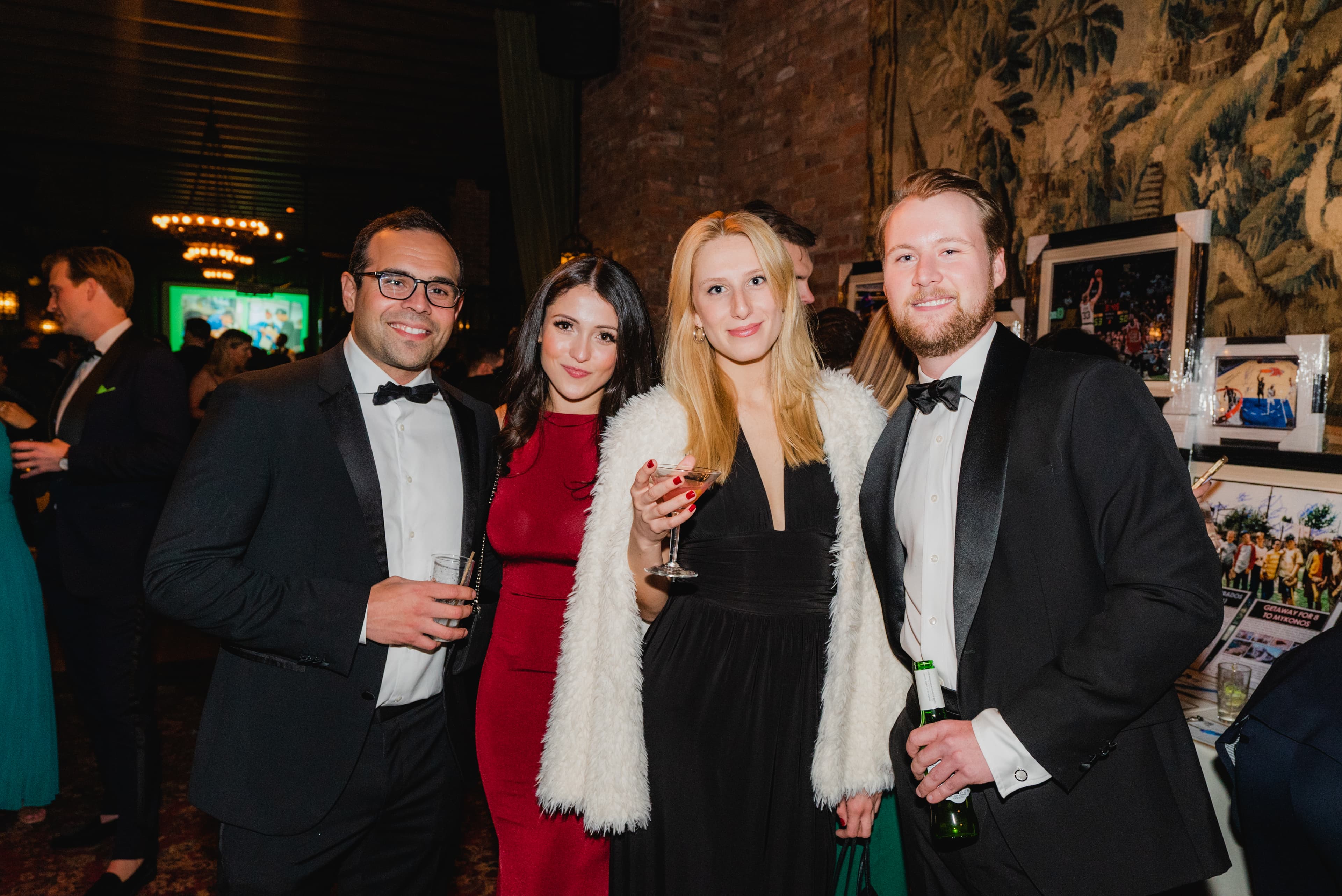 Four guests in formal attire at a gala